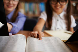 girl pointing to dictionary entry